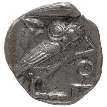 An owl and an olive sprig struck on a worn silver tetradrachm of Athens